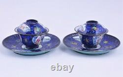 A pair of antique Chinese Canton enamel tea cups with saucers, 18thC