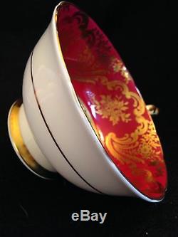 Stunning paragon tea cup Red ground with Gold Intricate Guilding And Mums